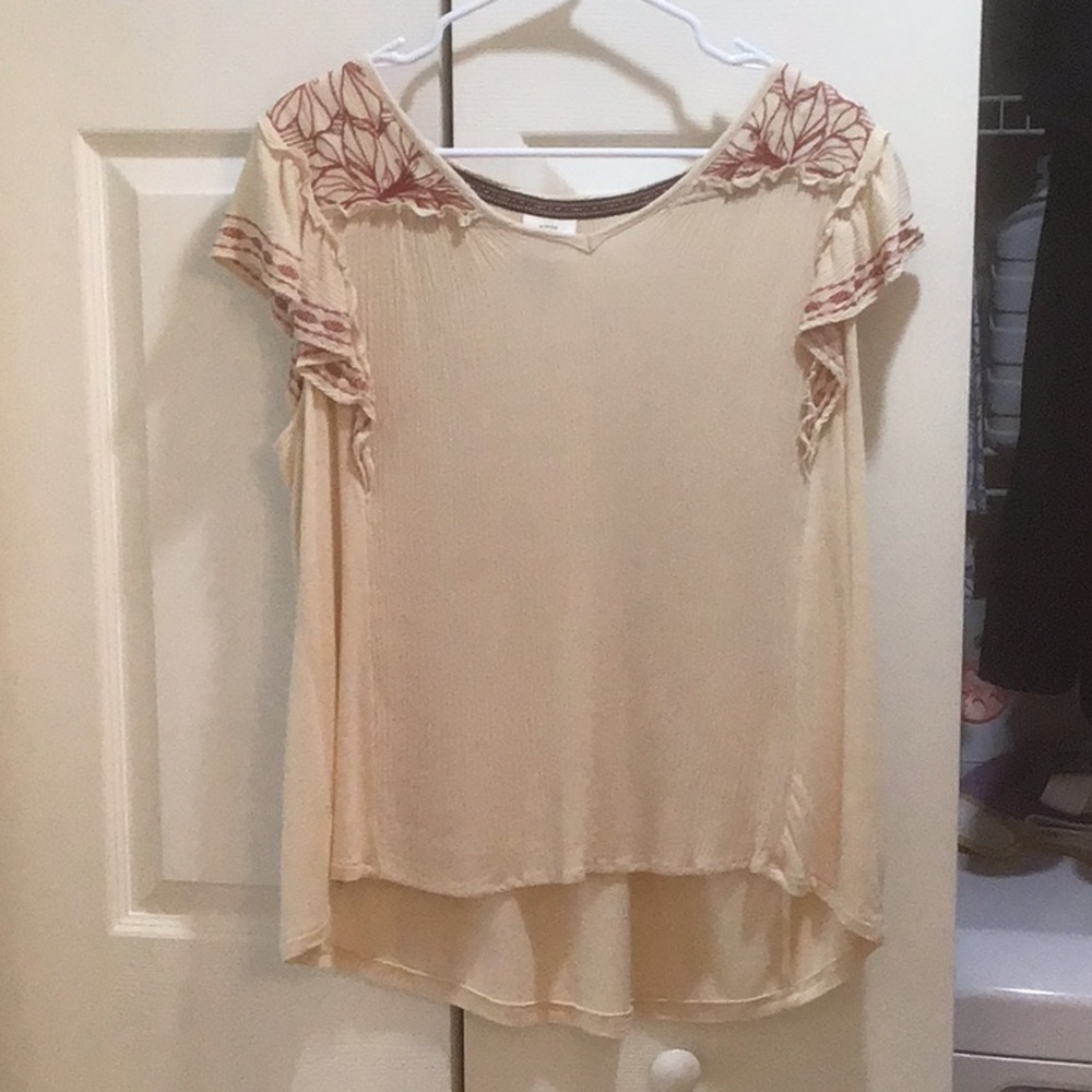 Knox Rose top in cream with beautiful dark red rust colored stitching detail.